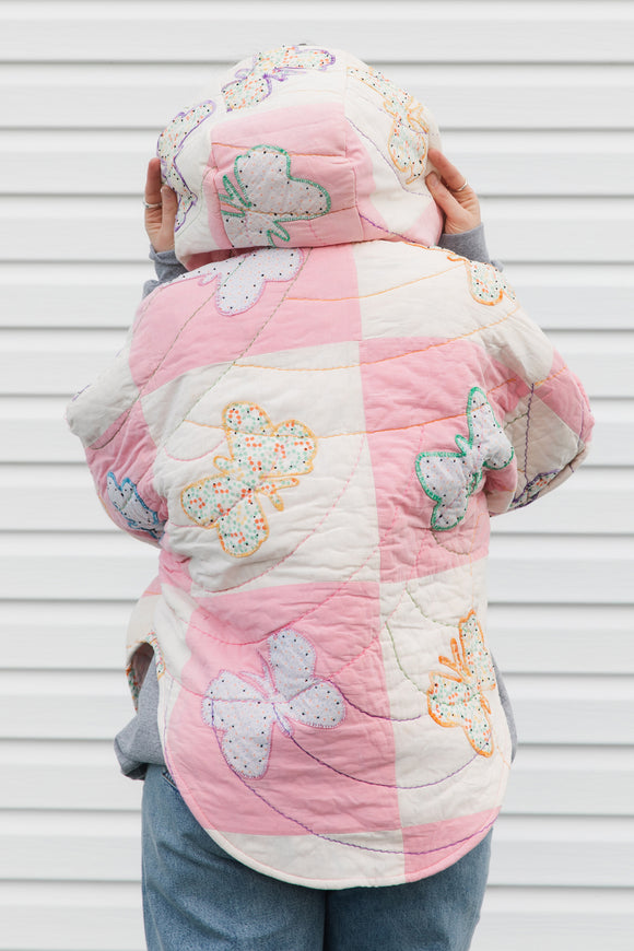 pink and white butterfly quilt turned poncho, featuring oversized hood, pockets and pretty purple buttons, repurposed in canada
