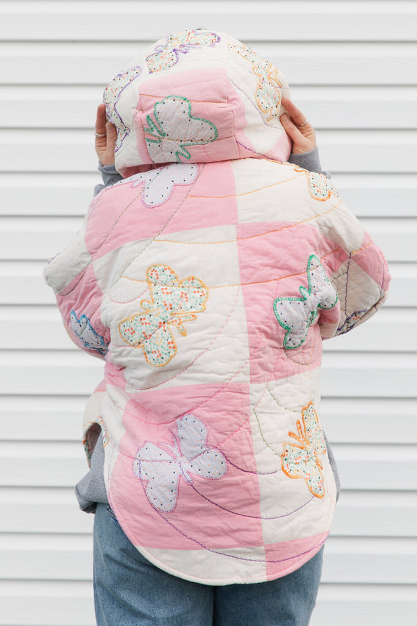 pink and white butterfly quilt turned poncho, featuring oversized hood, pockets and pretty purple buttons, repurposed in canada