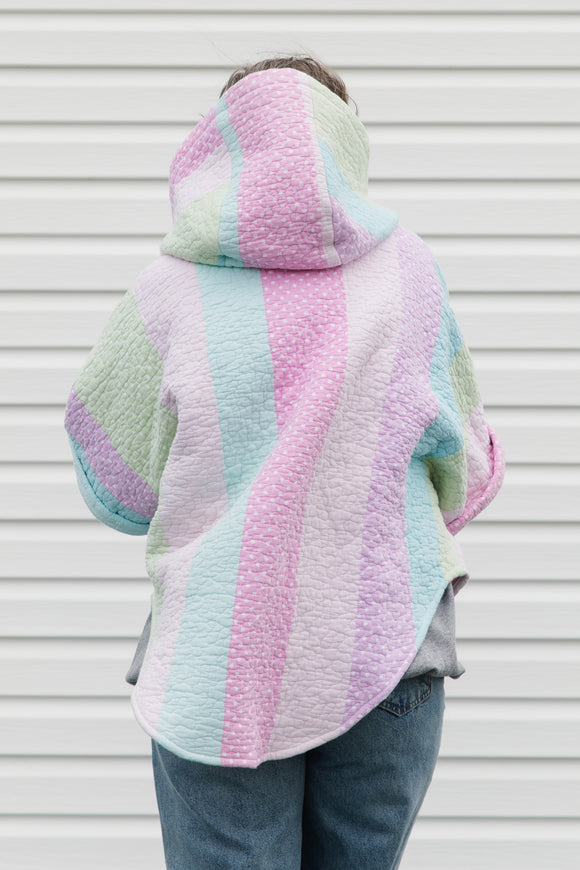 pink, green and blue pastel quilt turned poncho, with oversized hood, pockets and button up front, repurposed in canada