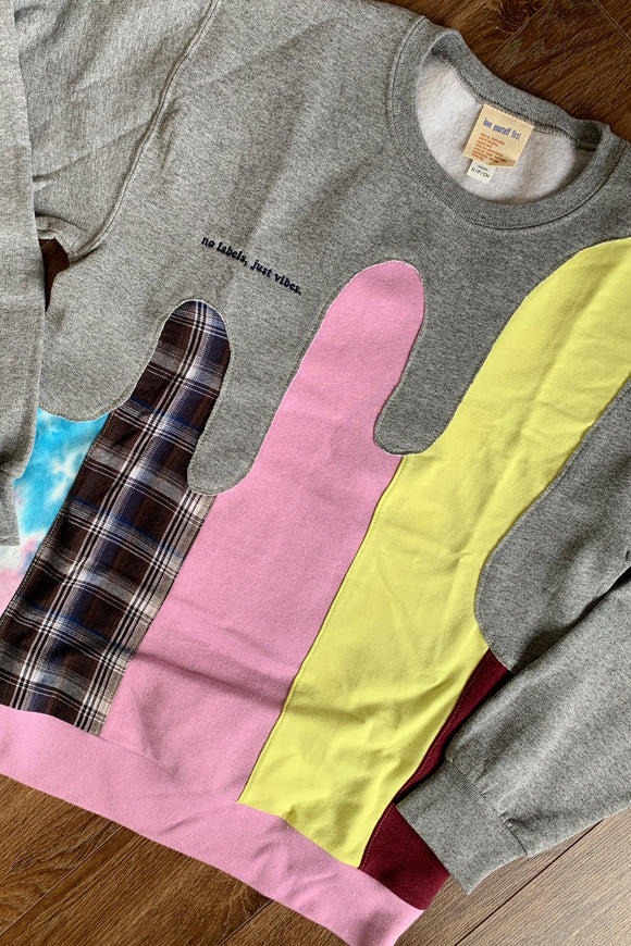 colourful upcycled sweater featuring yellow, pink and plaid details repurposed in canada