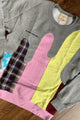 colourful upcycled sweater featuring yellow, pink and plaid details repurposed in canada