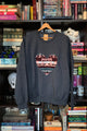 Woman wearing a dark gray sweatshirt with a colorful heart design sewn in canada
