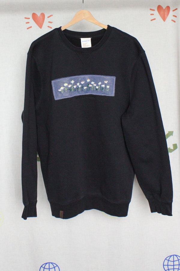 black sweater with daisy embroidery upcycled in canada