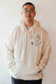 unisex cream hoodie with hand embroidered doodles, upcycled clothing, embroidered with no labels, just vibes on sleeve