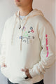 unisex cream hoodie with hand embroidered doodles, upcycled clothing, embroidered with no labels, just vibes on sleeve