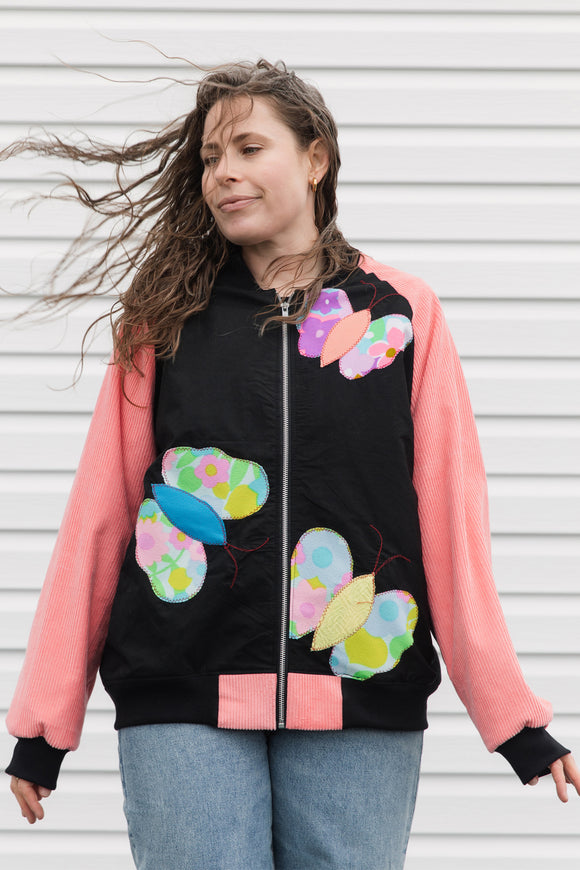 butterfly bomber jacket with pink cordruroy sleeves, upcycled and repurposed in canada