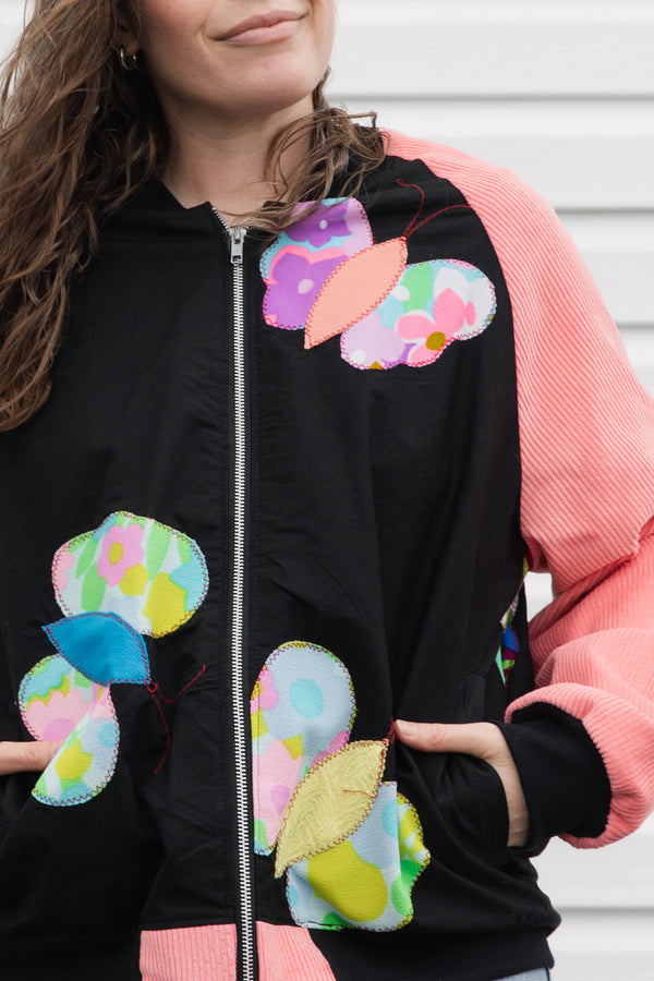 butterfly bomber jacket with pink cordruroy sleeves, upcycled and repurposed in canada