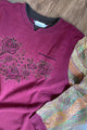 maroon norther reflections sweater with upcycled sleeves and floral detail, repurposed in canada