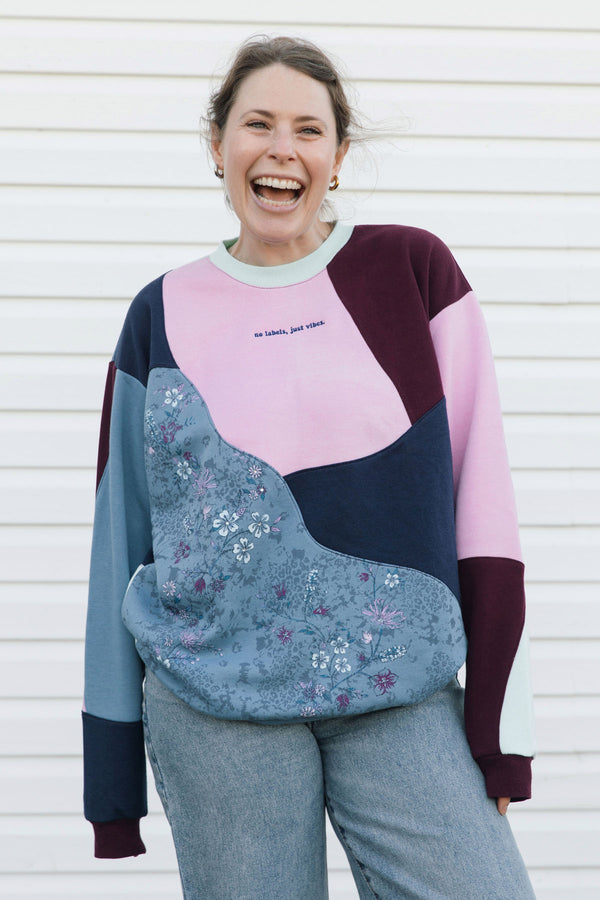colourful patchwork sweater, featuring pink, maroon, navy and beautiful blue floral print, upcycled in canada