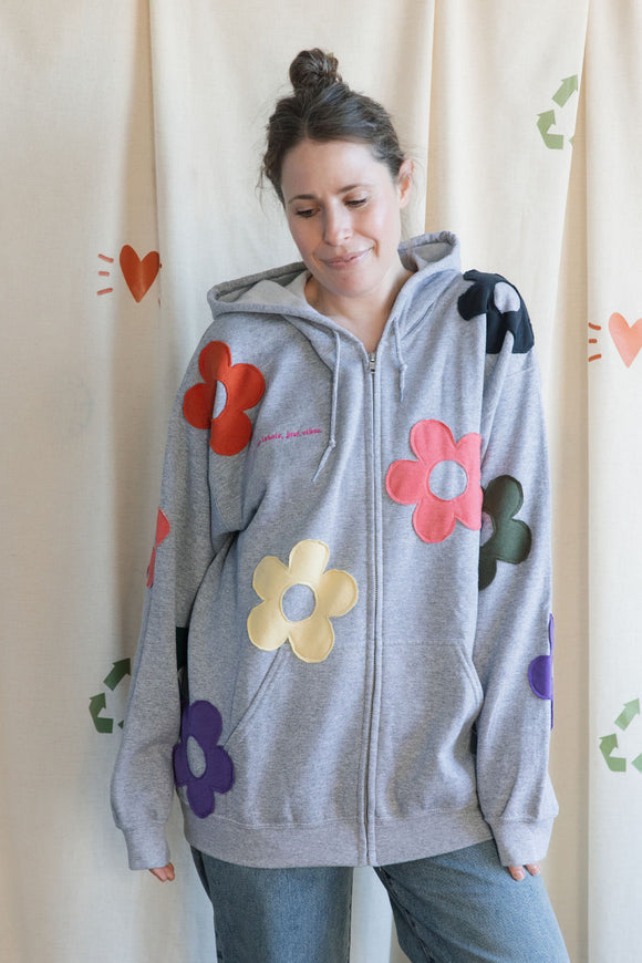 light grey zip up hoodie with colourful flowers all over, upcycled in canada