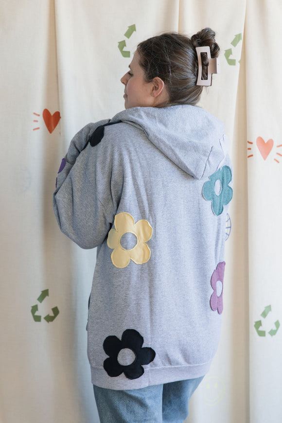 light grey zip up hoodie with colourful flowers all over, upcycled in canada