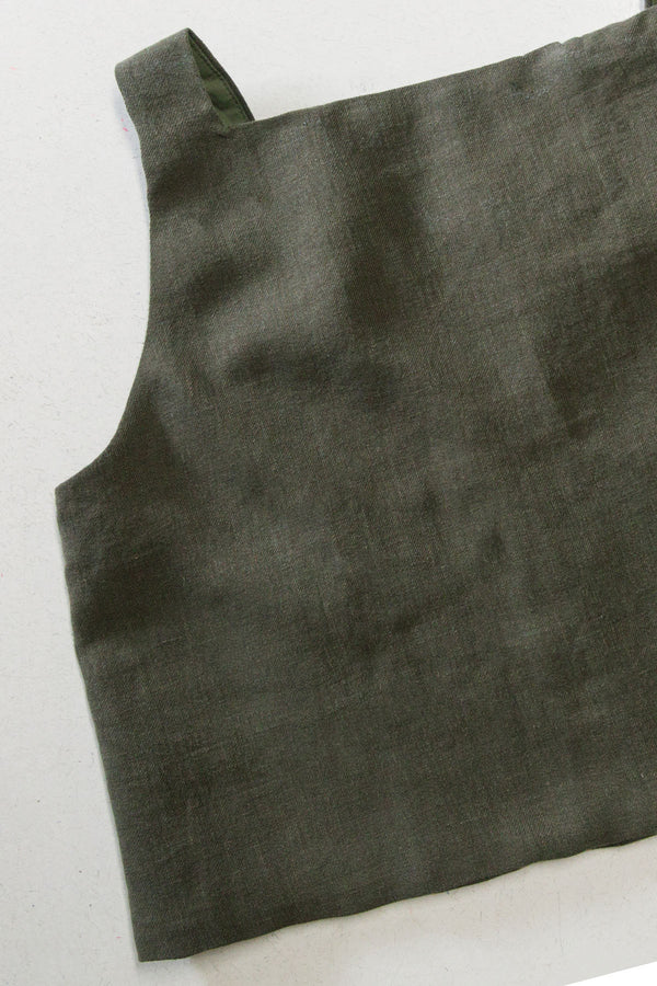 green sleeveless top on a light background