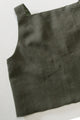 green sleeveless top on a light background