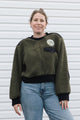 dark green fuzzy sweater, featuring no labels, just vibes patch and floral elbow patches, upcycled in canada