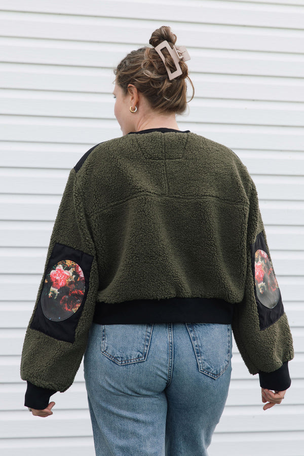 dark green fuzzy sweater, featuring no labels, just vibes patch and floral elbow patches, upcycled in canada