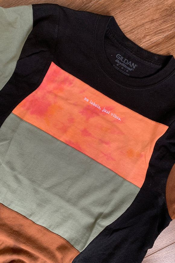 upcycled tshirt with black, orange, green and brown colours, repurposed in canada