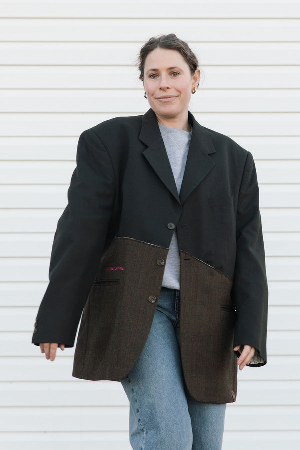 Person wearing a black and brown jacket against a white background