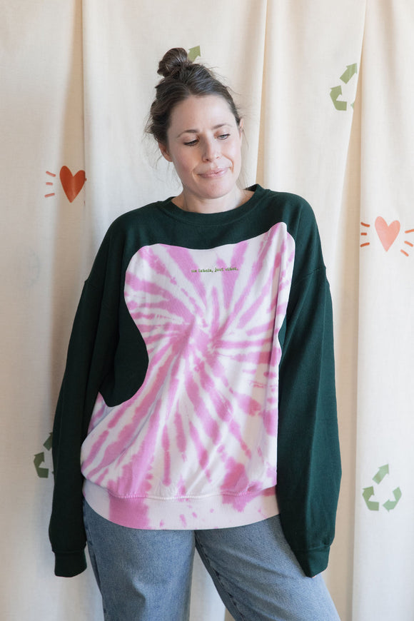 Person wearing a green and pink tie-dye sweatshirt, upcycled in canada