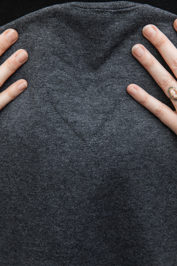 heart outline stitched on back neck of grey unisex sweater, made in canada