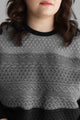 woman wearing oversized, comfy sweater with ombre grey to black design, handmade in Ottawa, cable knit design detail