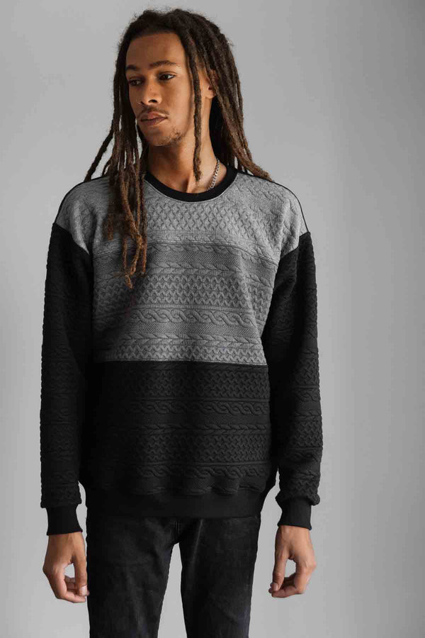 man wearing oversized, comfy sweater with ombre grey to black design, handmade in Ottawa, cable knit design detail