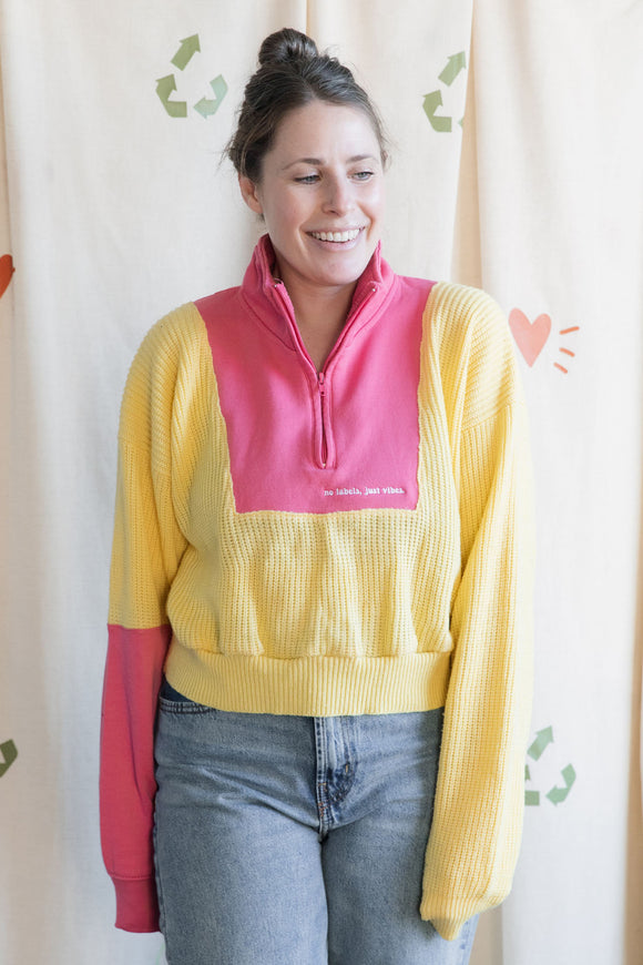 Woman wearing a yellow and pink sweater, upcycled in canada