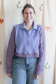 Woman wearing a purple button up sweater with collar, upcycled in canada