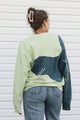 lime green sweater with purple detail and blue striped knit, upcycled in canada