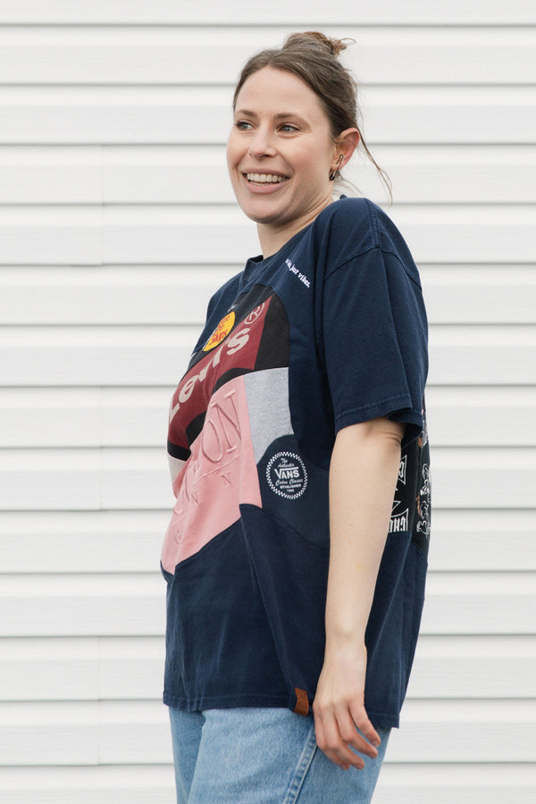 Person wearing an upcycled t-shirt featuring lots of different logos, made in canada