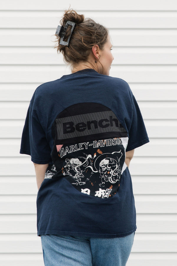 Person wearing an upcycled t-shirt featuring lots of different logos, made in canada