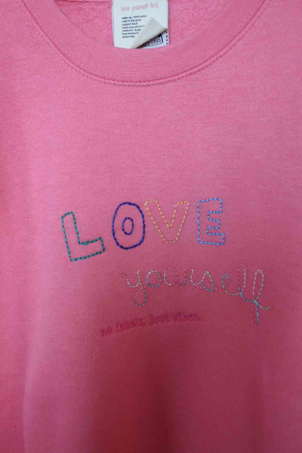 pink sweater with knit sleeves, embroidered with love yourself, upcycled clothing, thrifted fashion