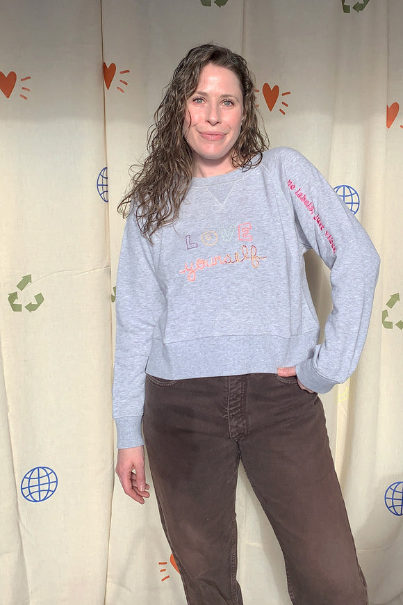 grey upcycled sweater with 'love yourself' embroidered detail, repurposed secondhand clothing