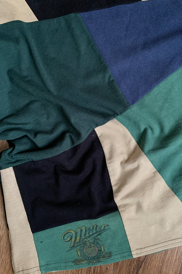 upcycled green, black & tan patchwork tee, featuring miller beer logo, repurposed in canada
