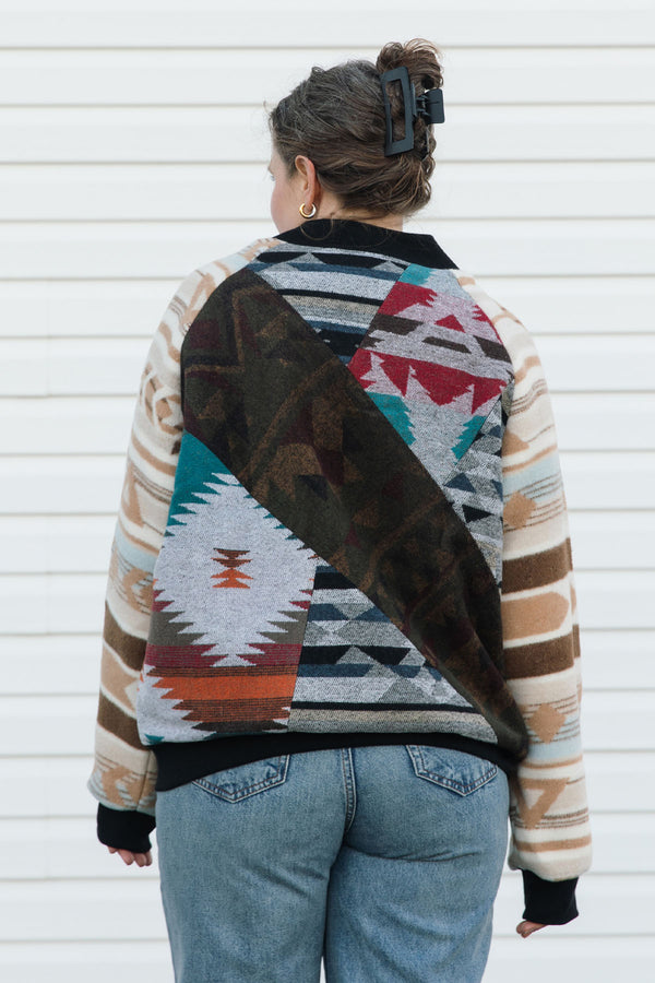 Person wearing a patterned jacket with a white background