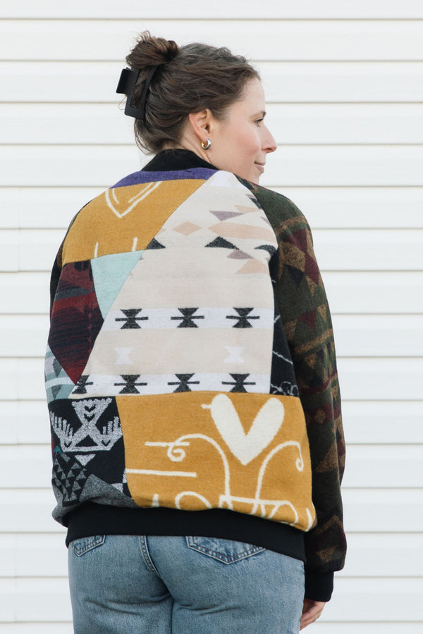 Person wearing a patterned jacket with a white background