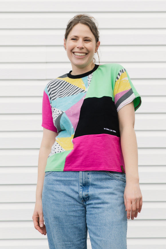Person wearing a colorful patterned shirt with a white background