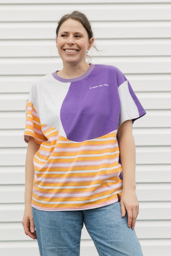 Woman wearing a colorful striped shirt with purple 