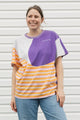 Woman wearing a colorful striped shirt with purple 