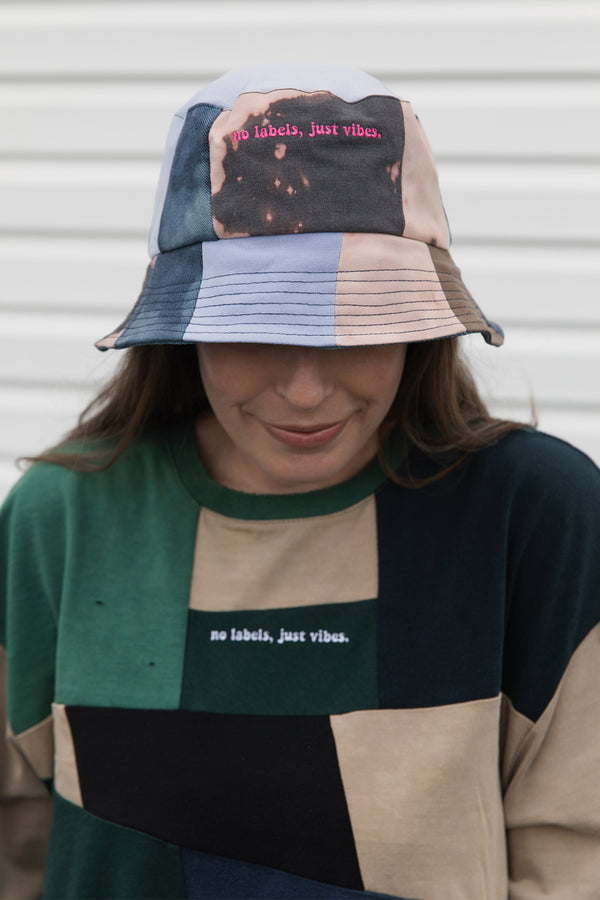 reversible patchwork bucket hat, colourful, one of a kind, each embroidered with 'no labels, just vibes.' made in canada