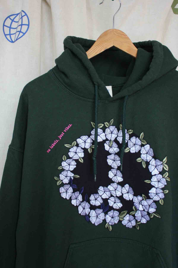 green hoodie with floral embroidered peace symbol, upcycled fashion