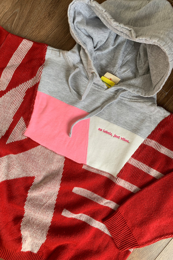 red sweater with grey hoodie and pops of pink upcycled in canada