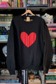 Black sweatshirt with a red striped heart design sewn in canada