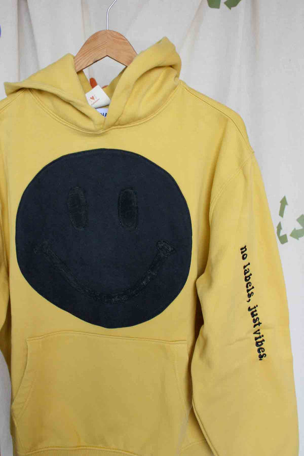 yellow hoodie with black smiley face on it, upcycled clothing