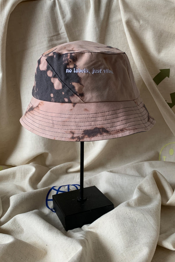 upcycled bucket hat, each one of a kind and embroidered with 'no labels, just vibes.' made in canada