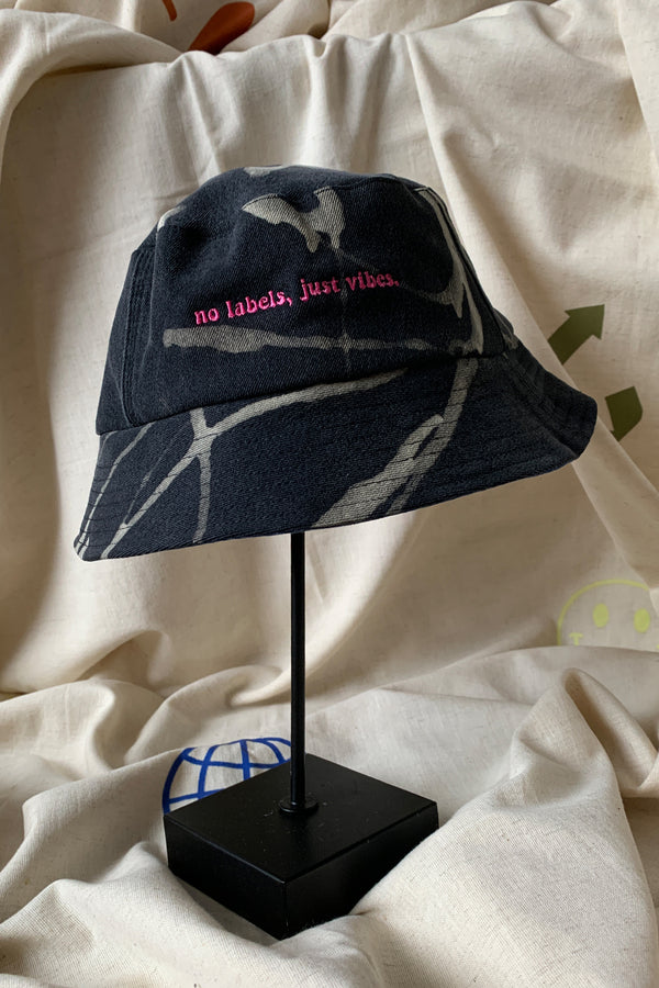 upcycled bucket hat, each one of a kind and embroidered with 'no labels, just vibes.' made in canada