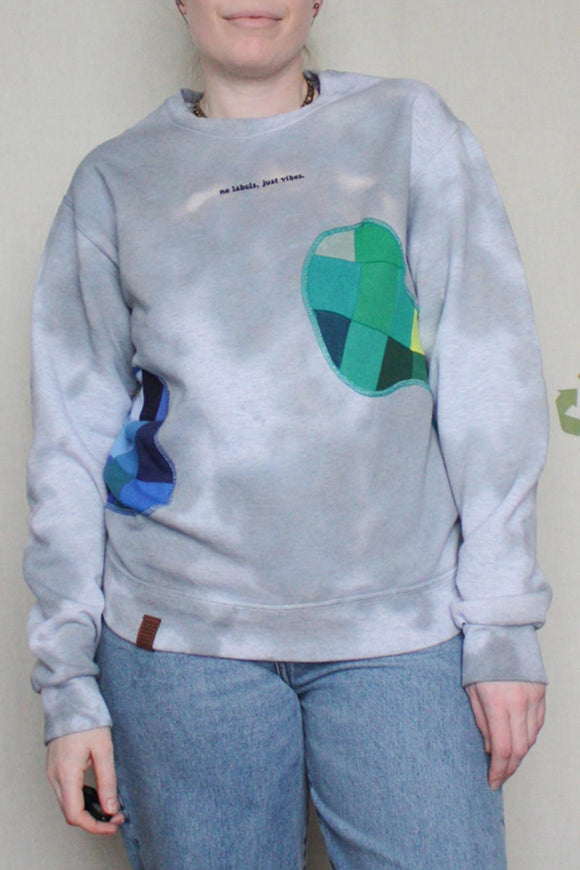 dyed sweater with patchwork cut outs, green and blue patches, upcycled in canada