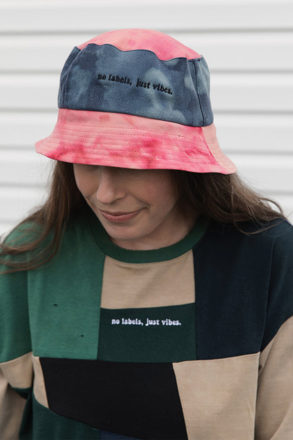 colourful upcycled bucket hat, each embroidered with 'no labels, just vibes.' and are reversible with solid colours, made in canada