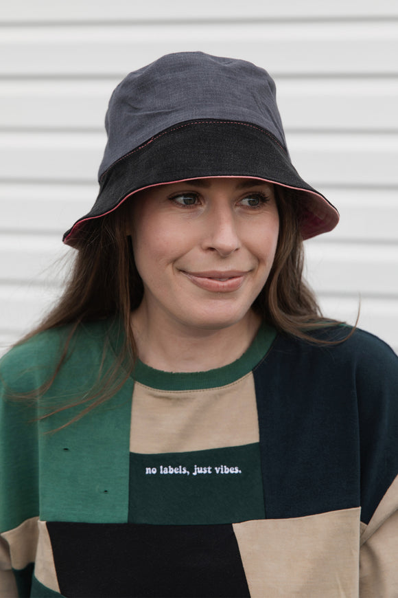 colourful upcycled bucket hat, each embroidered with 'no labels, just vibes.' and are reversible with solid colours, made in canada