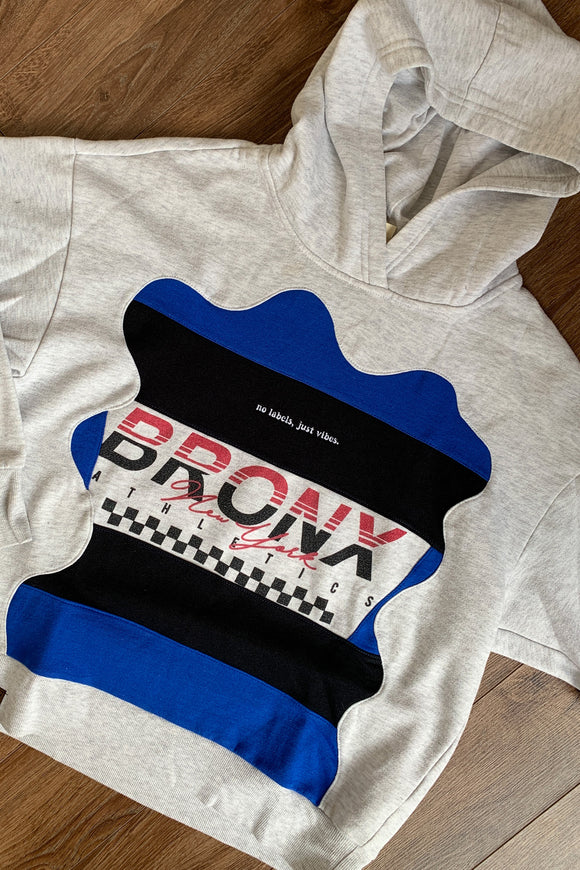grey hoodie featuring bronx new york logo and blue and black colours, upcycled in canada