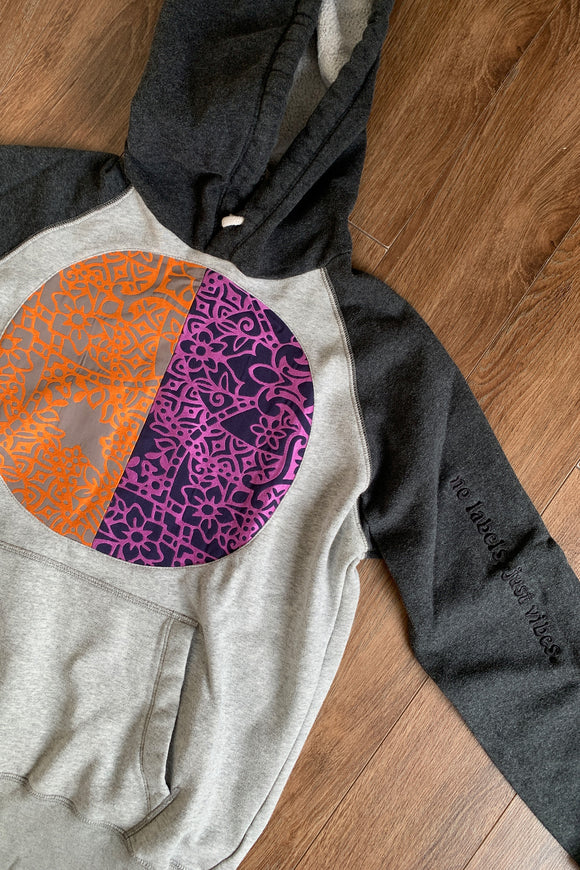 upcycled grey hoodie featuring colourful orange and purple motif, repurposed in canada